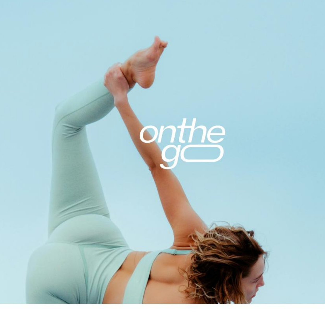 Woman in yoga pose against a sky-blue sky
